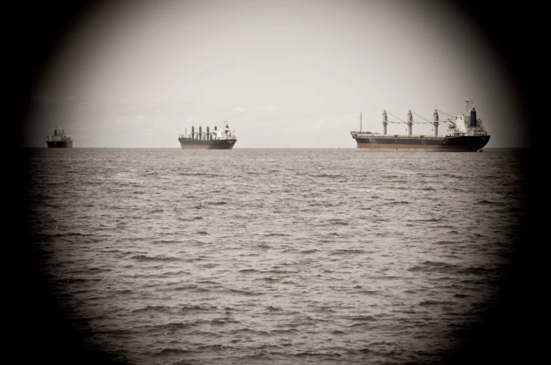 a few boats floating in the ocean next to each other