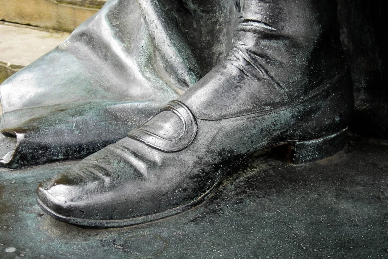 close up po of large silver statue's feet