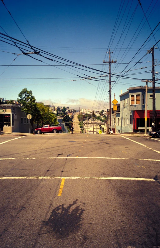 the street that has some electric wires going over it