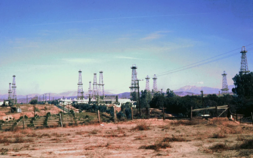 a desert is littered with sp grass and utility poles