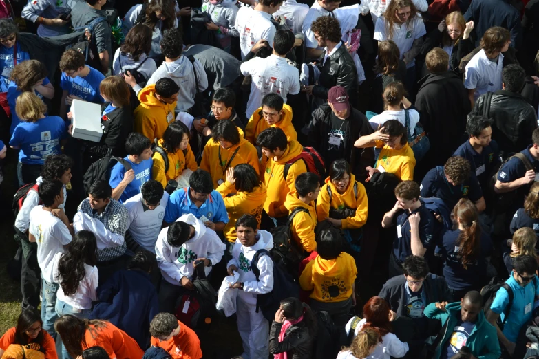 a crowd of people with yellow shirts standing next to each other