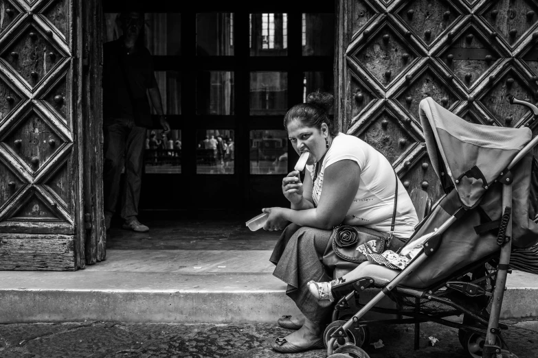 a woman sitting in her stroller while on her cell phone