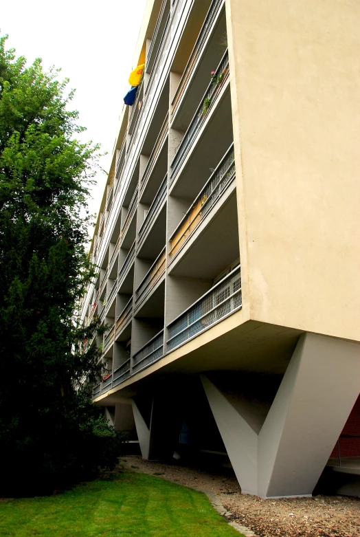 a large building with stairs and balconies in a park