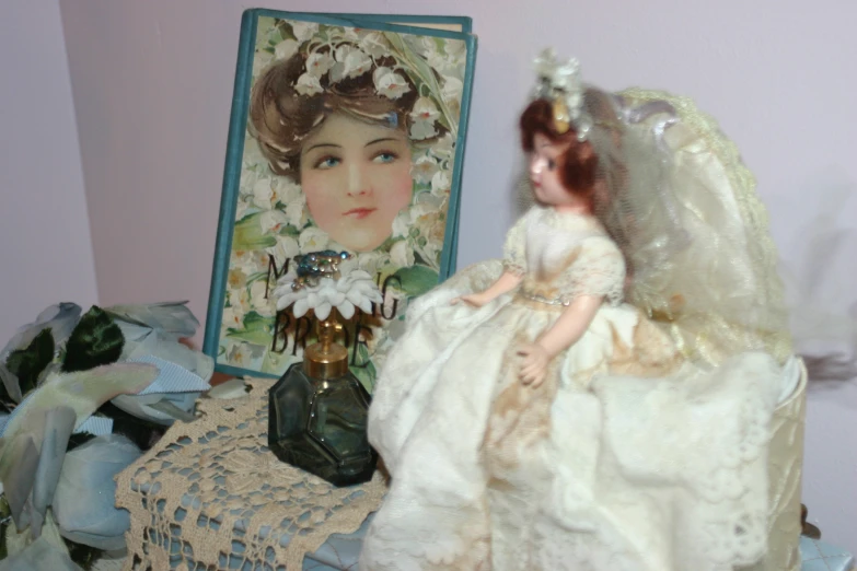 two porcelain dolls in wedding dress near painting and doll