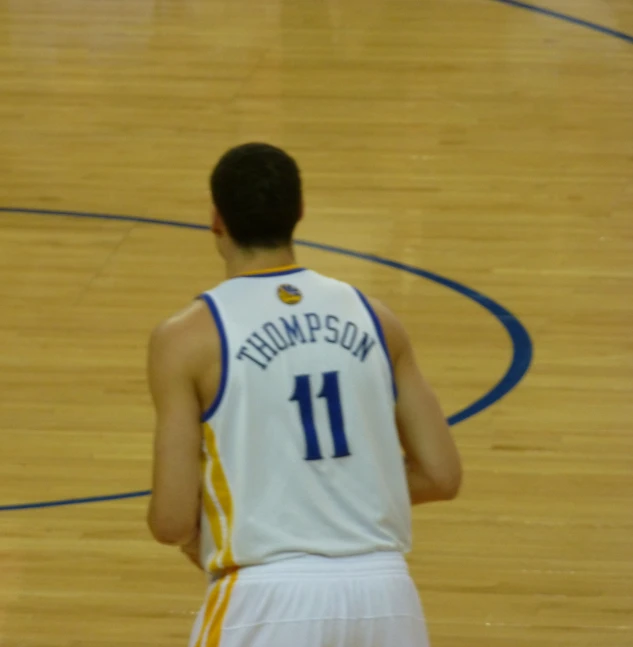 a basketball player looking down at the court