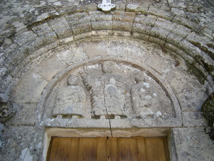 a tall building with a wooden door and a wall on it