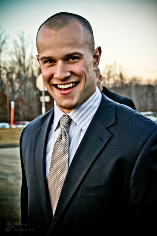 a man in a suit smiling for a picture