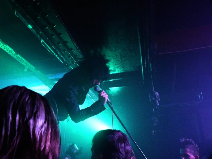 several people watching a band perform on stage