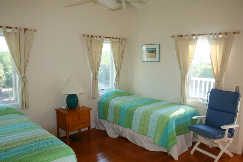 two beds in a room with wooden floors