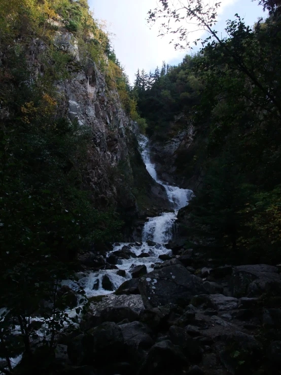 a stream in a canyon with water coming out of it