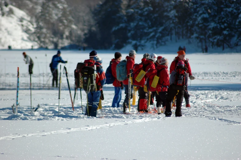 a group of skiers gather together on the slope