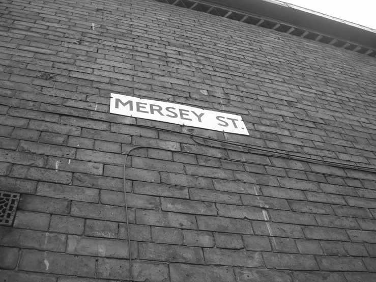 this brick building has a street sign on it