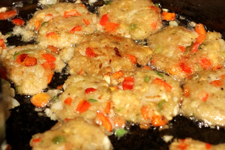 there is some kind of meat with vegetables in the frying pan