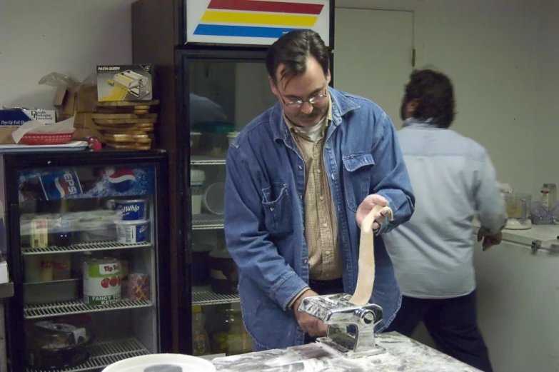 man looking at a bowl in front of the refrigerator