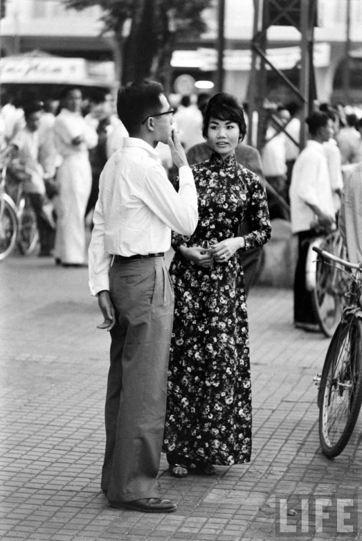 black and white po of people standing around looking at one another