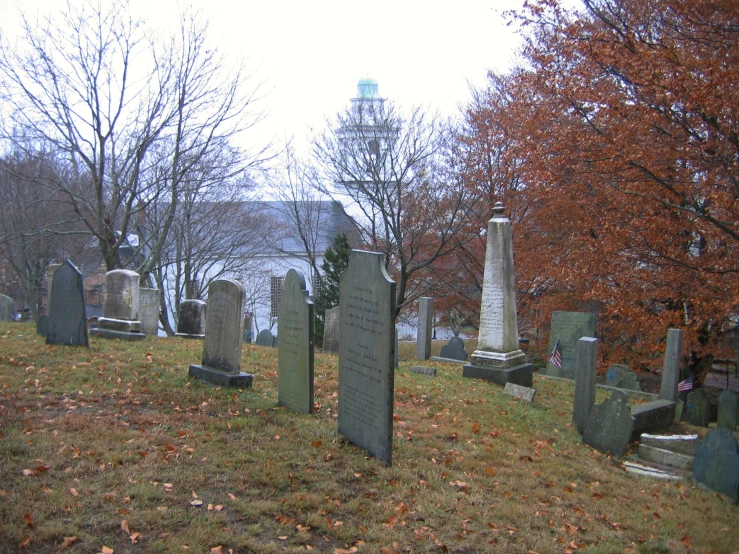 two headstones of people sitting in a cemetery