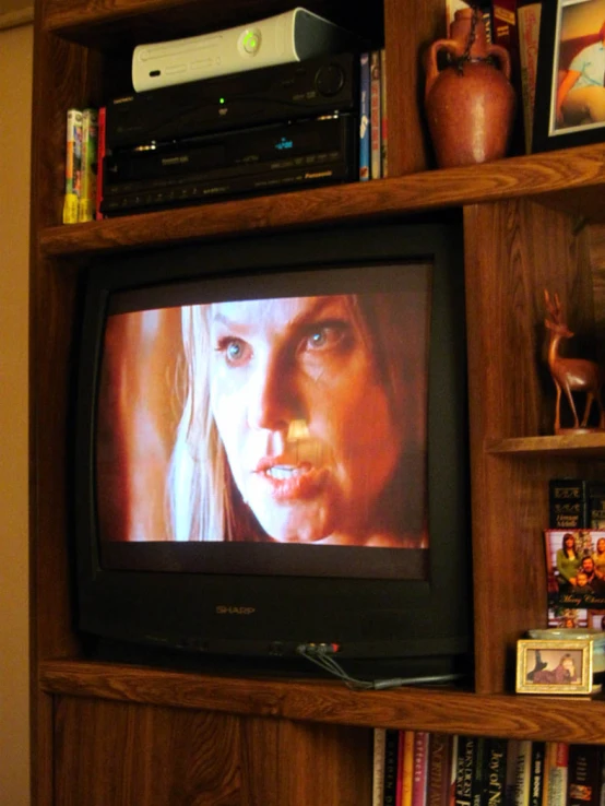 there is a television on the wall in front of many movies