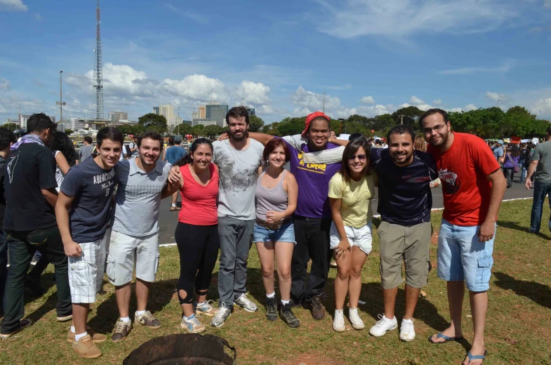 a group of people standing around in a park