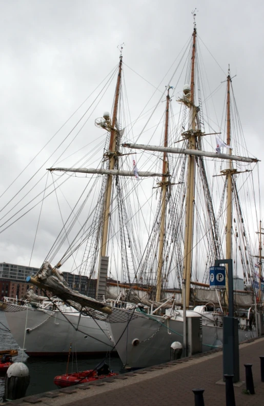 a large ship with sails and ropes tied to the mast