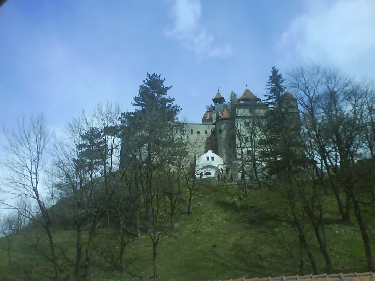 a large castle sitting on the side of a hill