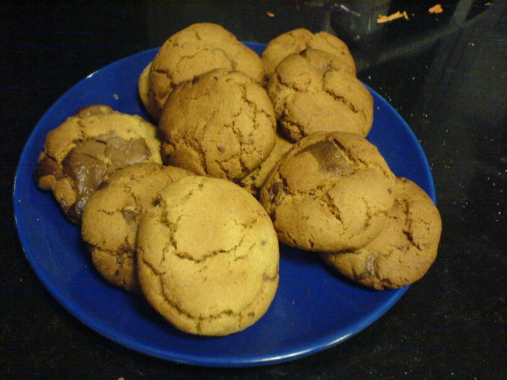 a blue plate topped with cookies on a counter