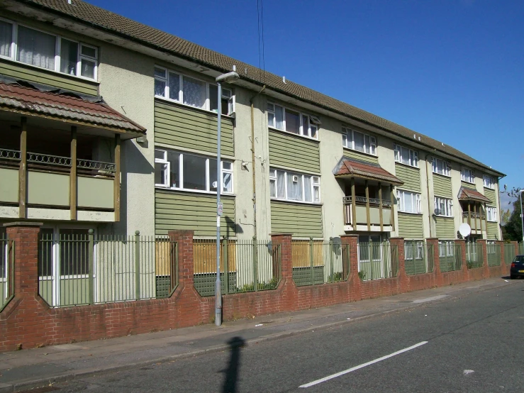 a row of apartment buildings in front of a street