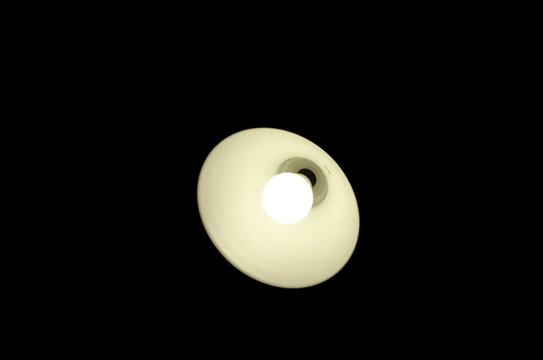 a black background with one small, circular object in the center