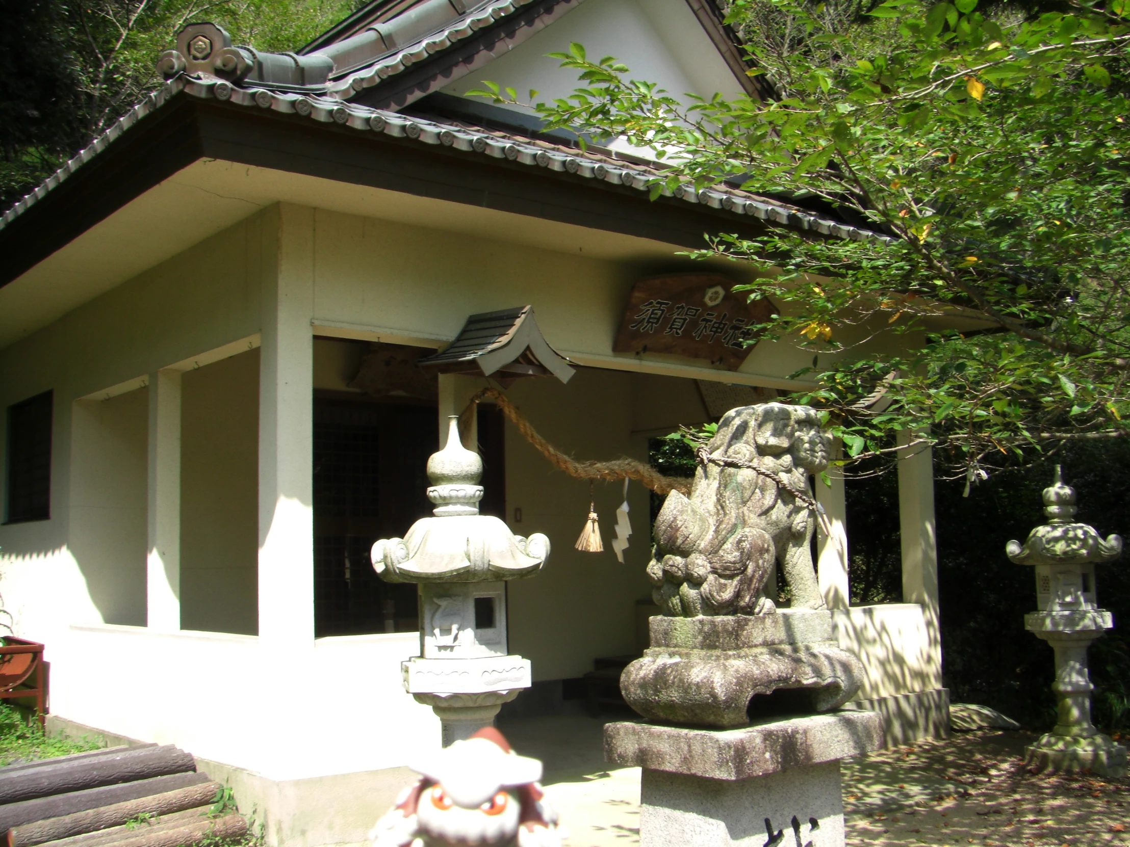 a small white building surrounded by statues of animals