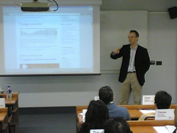 man giving a presentation in front of a classroom