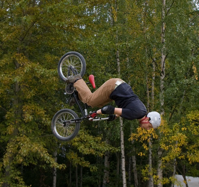 a man flying through the air while riding a motorcycle