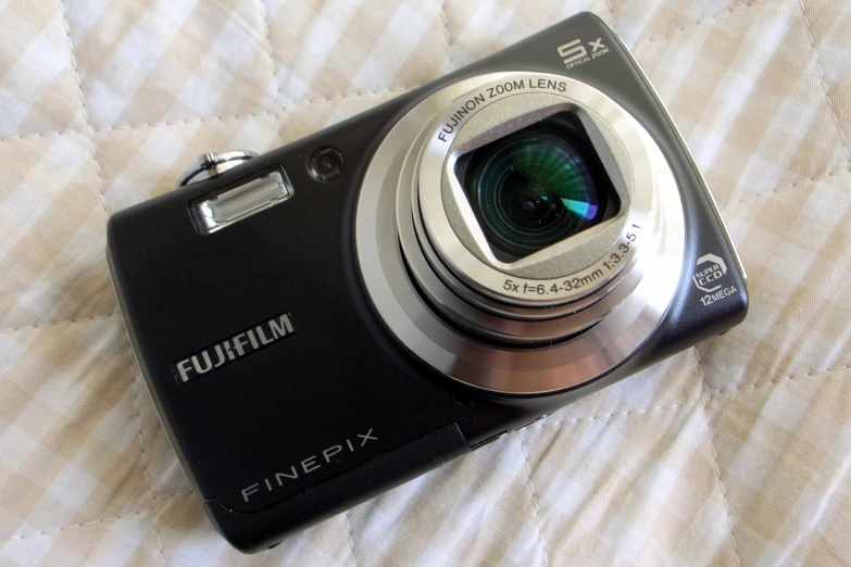 a camera sitting on top of a bed