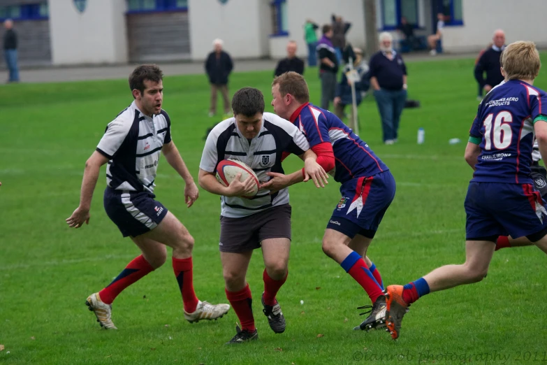 a rugby game between teams during the daytime