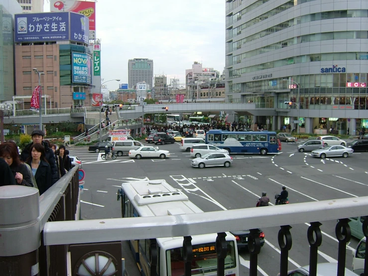 an asian street scene with cars driving by