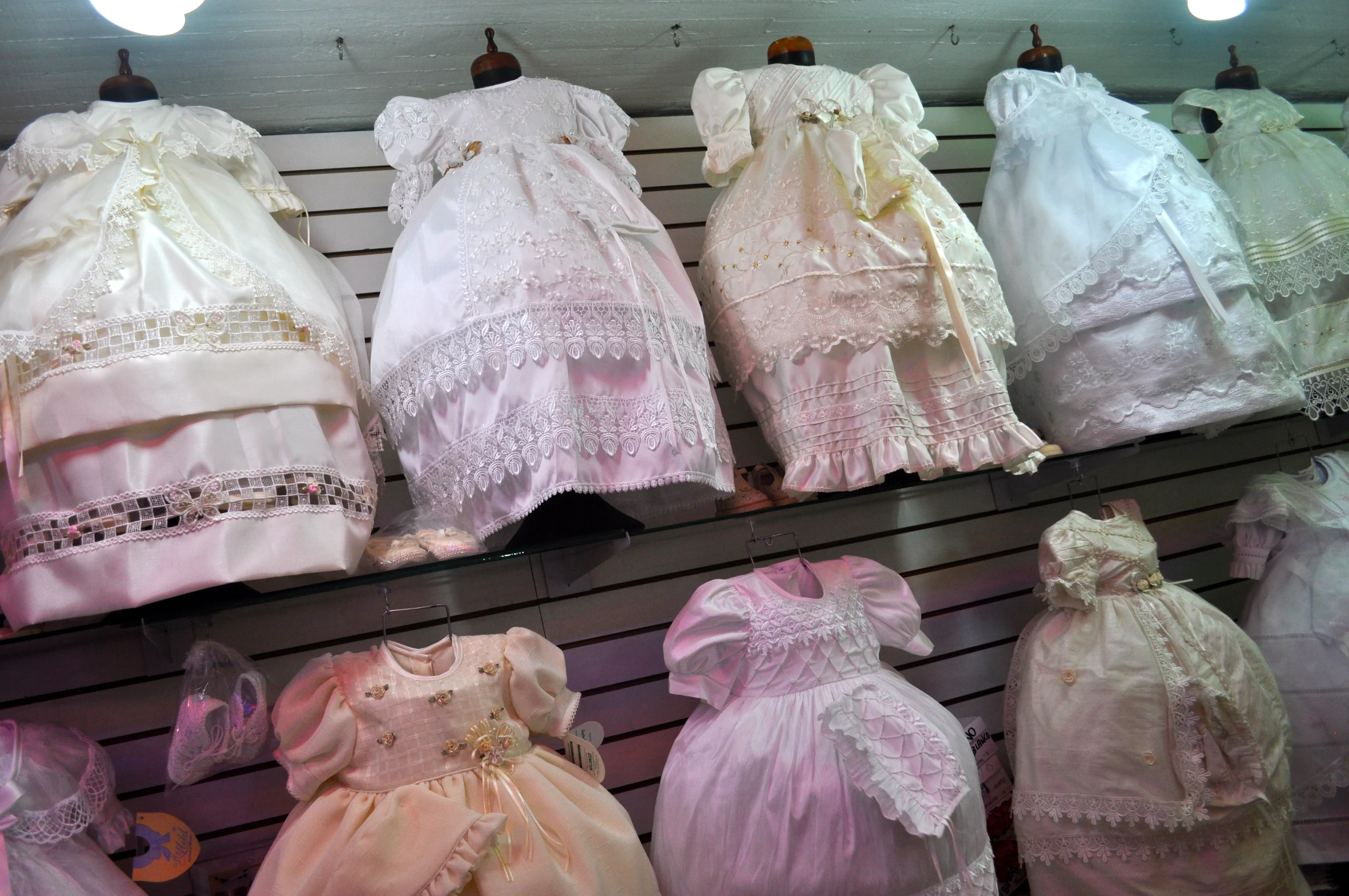 a bunch of dress clothes that are hanging on a rack