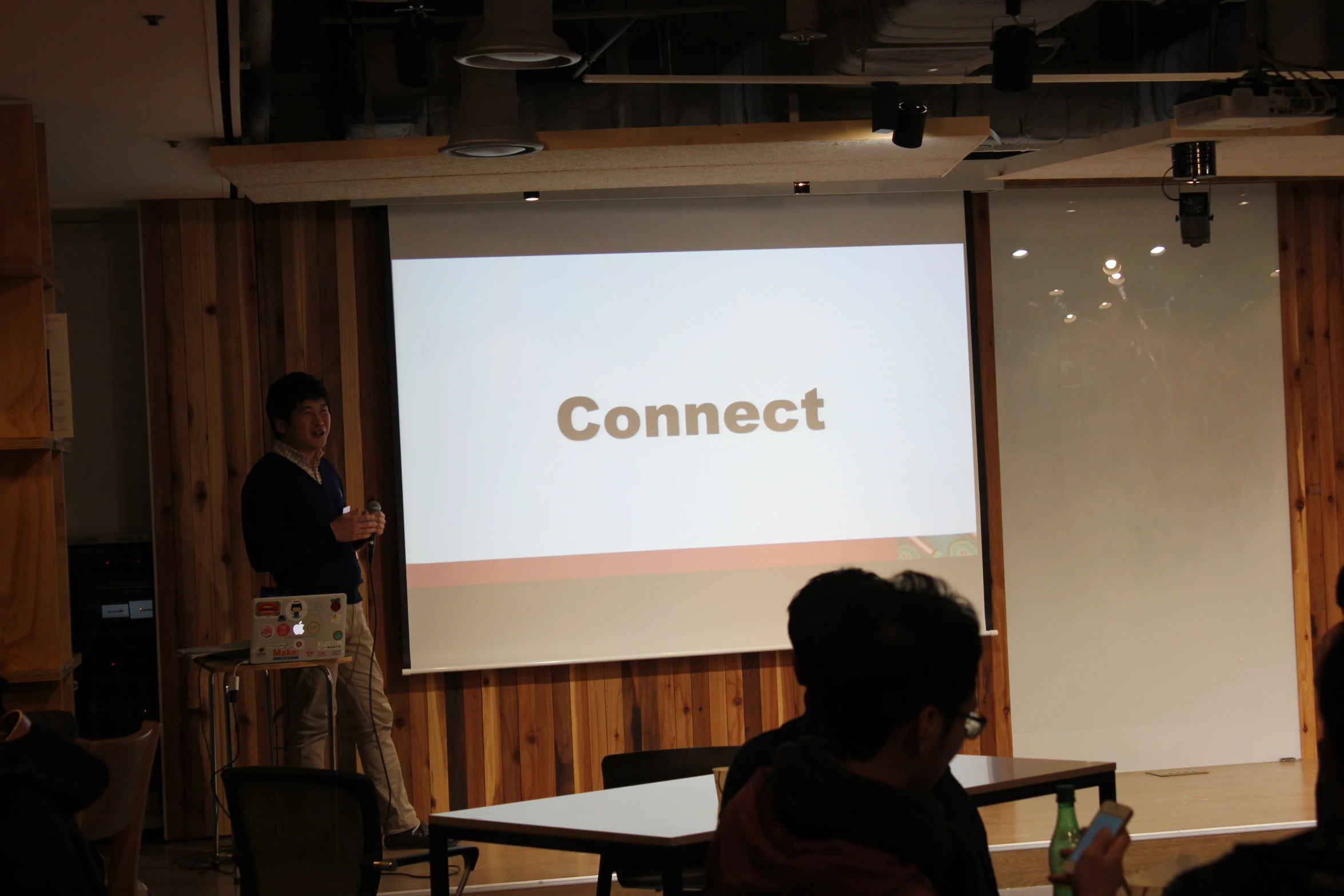 a man is presenting at a seminar on the computer