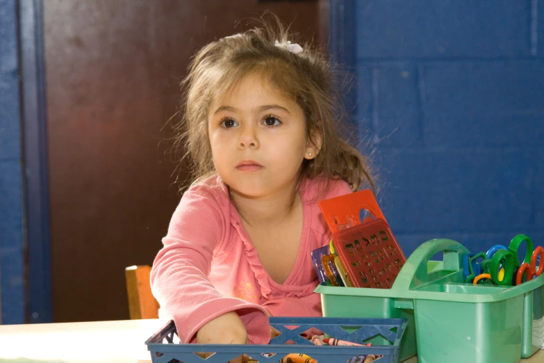 a child with an opened container and toy