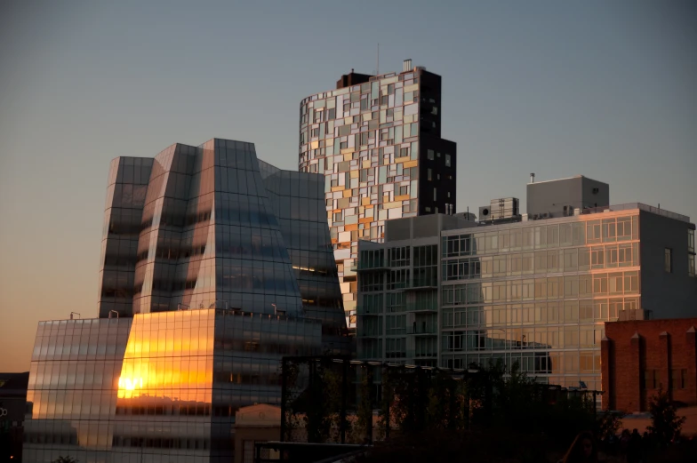 the buildings are lit up very brightly at sunset