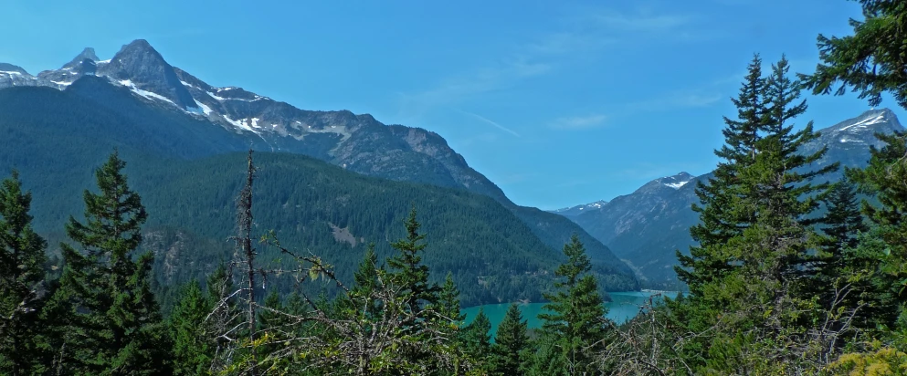 a scenic mountain range with some water in the background