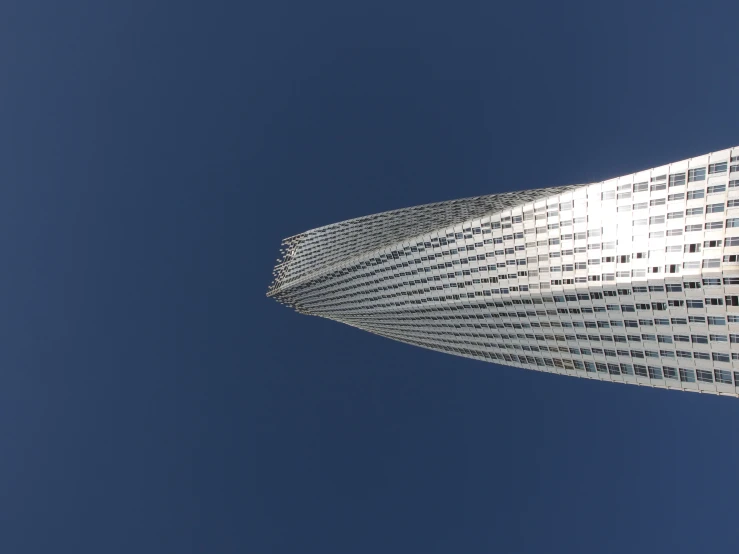 an airplane flies high in the blue sky