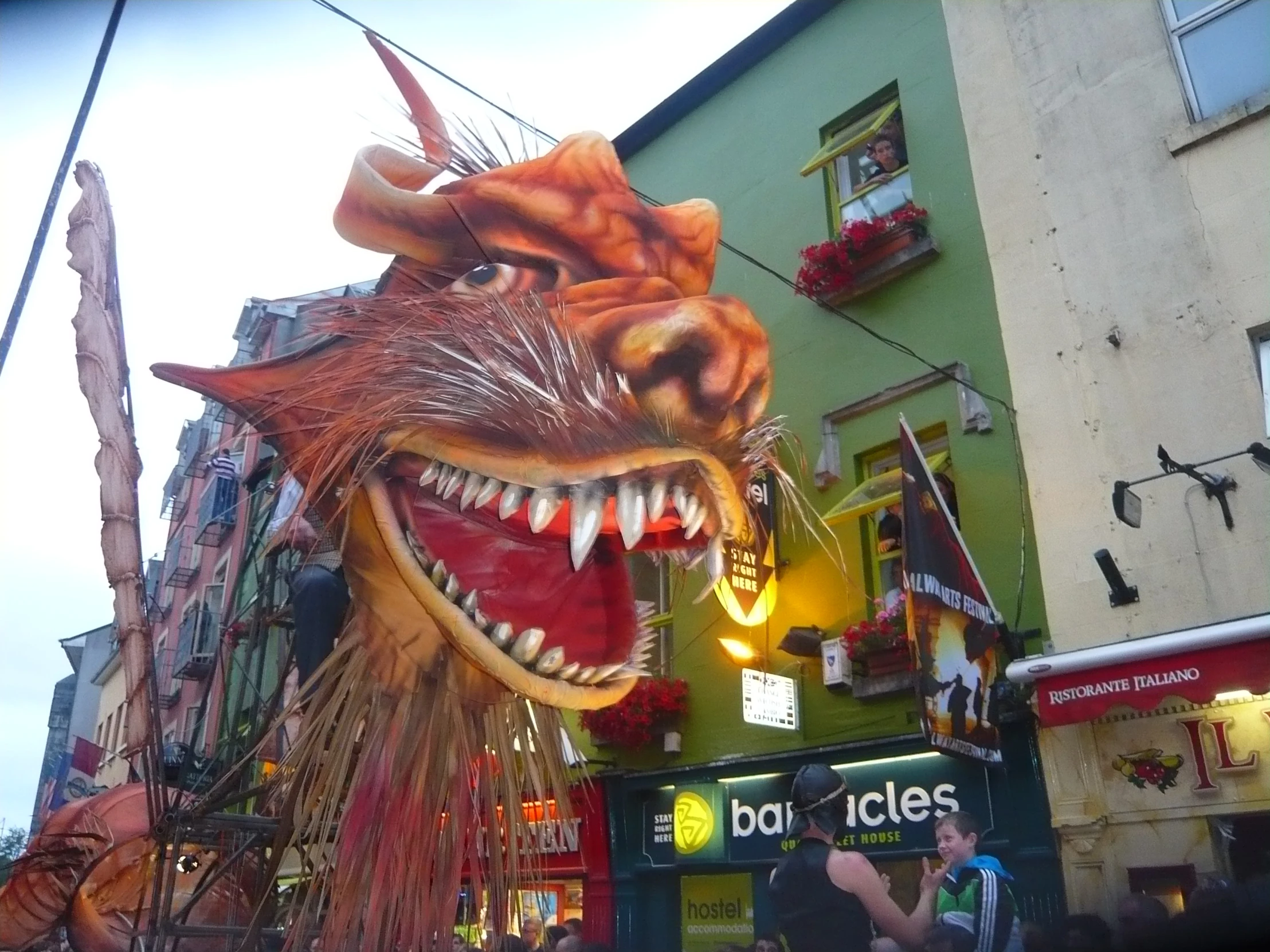 a giant dragon head at the center of a city street