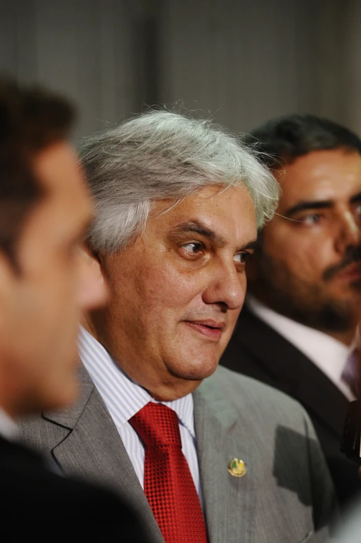 a group of men in suits and ties talking