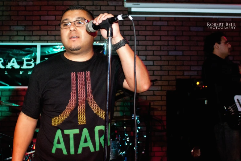 a man on a stage singing into a microphone