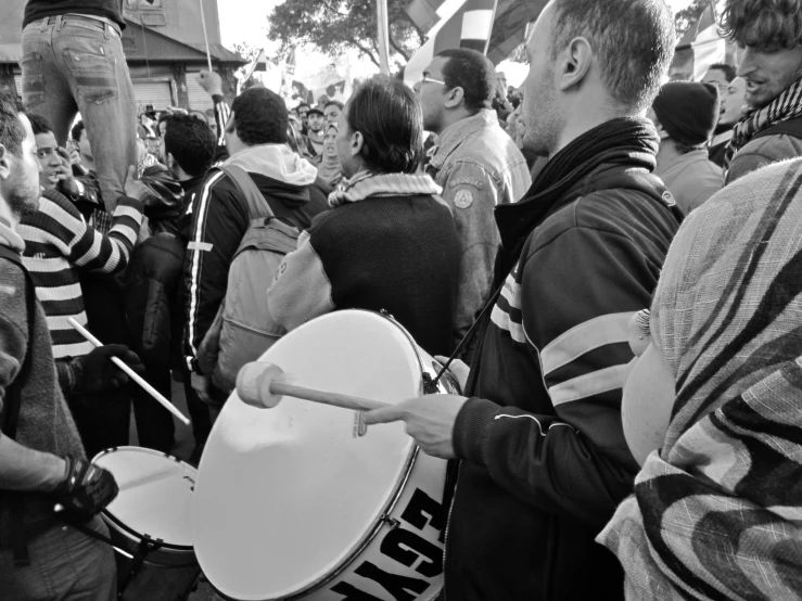 a large group of people standing next to each other with bags