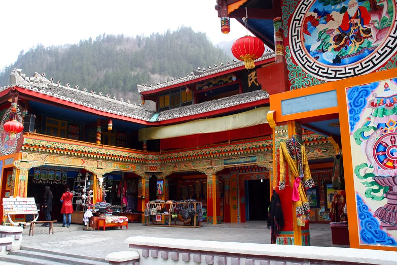 the front of a building with decorations hanging off of the roof