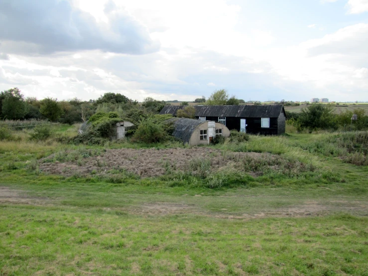 an old, rundown house is seen in the distance