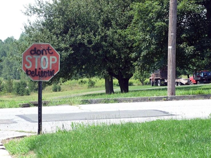 a close up of a stop sign in front of a field