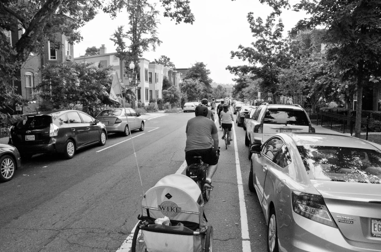 a man walking a dog on a leash while hing a stroller