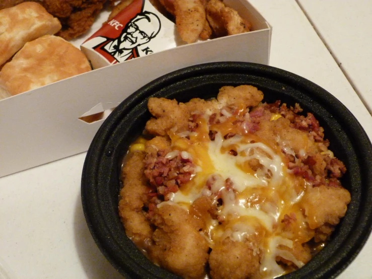 a meal in a black container with a large sandwich