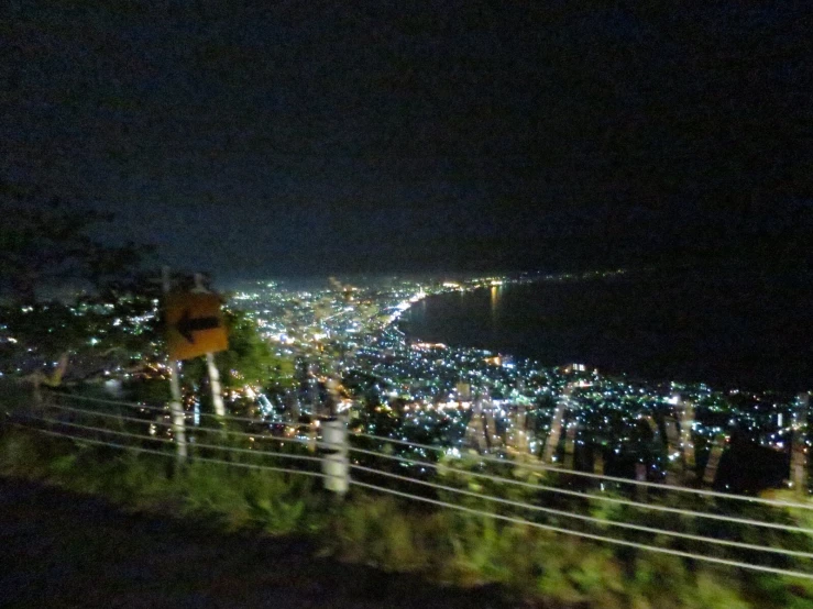 a crowd of people gathered at the top of a hill at night