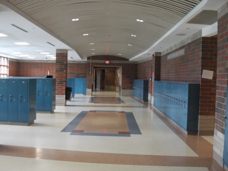 a hallway with lockers in the middle is empty